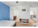 This bedroom includes a storage unit, blue accent wall, and access to a private bathroom and loft at 14920 Munich Ave, Parker, CO 80134
