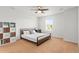 Bright bedroom with a large window, carpet floors, a ceiling fan, and a comfortable bed at 14920 Munich Ave, Parker, CO 80134