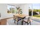 Bright dining area with large windows, hardwood floors, and access to the backyard at 14920 Munich Ave, Parker, CO 80134