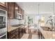 Modern kitchen with stainless steel appliances, granite countertops, and access to the dining area at 14920 Munich Ave, Parker, CO 80134