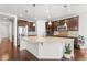 Modern kitchen featuring a large center island, stainless steel appliances, and dark wood cabinets at 14920 Munich Ave, Parker, CO 80134