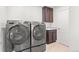 Convenient laundry room equipped with a modern washer and dryer, plus a utility sink at 14920 Munich Ave, Parker, CO 80134