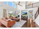 Bright living room featuring high ceilings, large windows, a fireplace, and wood floors at 14920 Munich Ave, Parker, CO 80134