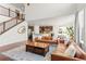 Open-concept living room with a view of the kitchen and a staircase leading upstairs at 14920 Munich Ave, Parker, CO 80134