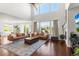 Spacious living room filled with natural light featuring wood floors, a fireplace, and tall windows at 14920 Munich Ave, Parker, CO 80134