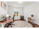 Well-lit office space with hardwood floors, a blue rug, and a large window at 14920 Munich Ave, Parker, CO 80134