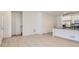 Bright, open-concept living area featuring laminate flooring, stainless steel appliances, a breakfast bar, and white walls at 2006 S Haleyville Way, Aurora, CO 80018