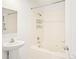 Bathroom with a pedestal sink and tiled bath-shower combo at 300 W 11Th Ave # 6G, Denver, CO 80204