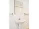Bathroom featuring a pedestal sink with a mirror and a towel rack at 300 W 11Th Ave # 6G, Denver, CO 80204