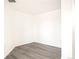 Empty room showcasing a spacious bedroom with gray wood-look flooring and freshly painted white walls at 300 W 11Th Ave # 6G, Denver, CO 80204