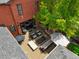 Aerial view of a luxurious backyard featuring an outdoor fireplace, hot tub, dining area, and comfortable seating, perfect for entertaining at 2153 S Columbine St, Denver, CO 80210