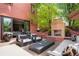 Inviting backyard featuring an outdoor fireplace, comfortable seating, and lush greenery, perfect for relaxation and entertaining at 2153 S Columbine St, Denver, CO 80210