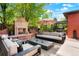 Charming outdoor patio with fireplace, comfortable seating, and manicured landscaping at 2153 S Columbine St, Denver, CO 80210
