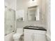 Bathroom featuring a vanity with a dark countertop and a glass-enclosed shower/tub combo at 2153 S Columbine St, Denver, CO 80210