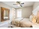 Bedroom with a queen bed, a ceiling fan, and a large decorative mirror at 2153 S Columbine St, Denver, CO 80210