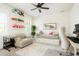 Bright bedroom with a daybed, an armchair, and built-in shelving with playful decor at 2153 S Columbine St, Denver, CO 80210