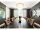 Elegant dining room with dark walls, sophisticated lighting, and ample seating at 2153 S Columbine St, Denver, CO 80210