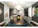 Elegant dining room with dark wood table, tufted chairs, and bright chandelier at 2153 S Columbine St, Denver, CO 80210