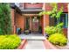 Inviting front porch with elegant wood door, stylish decor, and ample space for seating at 2153 S Columbine St, Denver, CO 80210