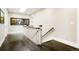 Hallway with dark hardwood floors, white railings, and natural light from a skylight at 2153 S Columbine St, Denver, CO 80210