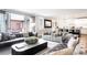 Open-concept living room boasts modern decor, plush seating, and seamless access to the outdoor patio at 2153 S Columbine St, Denver, CO 80210
