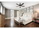 Spacious main bedroom featuring dark wood floors, a ceiling fan, and an upholstered headboard at 2153 S Columbine St, Denver, CO 80210