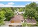This aerial view captures the expansive roof of the home, accented by verdant trees and neighborhood charm at 1475 S Urban Way, Lakewood, CO 80228