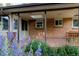 Covered back patio featuring skylights, brick accents, and garden view at 1475 S Urban Way, Lakewood, CO 80228