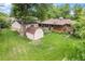 Expansive backyard with lush greenery, a storage shed, and mature trees at 1475 S Urban Way, Lakewood, CO 80228