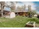 Spacious backyard featuring a lush lawn, shed, mature trees, and well-kept landscaping at 1475 S Urban Way, Lakewood, CO 80228