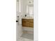 Bathroom vanity with marble top, gold faucet and natural wood cabinet at 1475 S Urban Way, Lakewood, CO 80228
