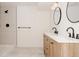 Modern bathroom with double sinks, a wooden vanity, and a sleek, tiled walk-in shower at 1475 S Urban Way, Lakewood, CO 80228