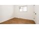 Cozy bedroom with hardwood floors, a window providing natural light, and clean, white walls at 1475 S Urban Way, Lakewood, CO 80228