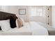 Bedroom features a well-lit window, neutral paint and comfortable bedding for a relaxing space at 1475 S Urban Way, Lakewood, CO 80228