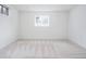 Well-lit bedroom featuring neutral carpeting, ample lighting, and a large, bright window at 1475 S Urban Way, Lakewood, CO 80228