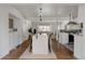 Bright dining room with hardwood floors, natural light, and seamless flow into the kitchen and living areas at 1475 S Urban Way, Lakewood, CO 80228