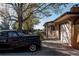 Charming brick home with a vintage car parked in the driveway under a mature tree at 1475 S Urban Way, Lakewood, CO 80228