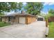 Charming brick home showcasing an attached 1-car garage and detached 2-car garage at 1475 S Urban Way, Lakewood, CO 80228