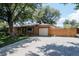 Brick house with attached garage, large driveway, and beautiful lawn at 1475 S Urban Way, Lakewood, CO 80228