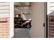 Garage entrance featuring a glimpse of a classic car, with a brick accent wall at 1475 S Urban Way, Lakewood, CO 80228