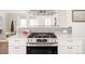 Modern kitchen with stainless steel appliances, gas range, white countertops, and white cabinets for a clean aesthetic at 1475 S Urban Way, Lakewood, CO 80228