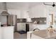 Well-lit kitchen with white cabinets, stainless steel appliances, modern backsplash, and a functional layout for cooking at 1475 S Urban Way, Lakewood, CO 80228