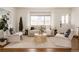 Bright living room with large windows, modern furniture, neutral tones, and hardwood floors, offering a cozy atmosphere at 1475 S Urban Way, Lakewood, CO 80228