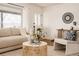 Inviting living room featuring stylish decor, hardwood floors, ample natural light, and comfortable seating arrangement at 1475 S Urban Way, Lakewood, CO 80228