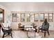 Sunroom with natural light, light-colored walls, hardwood floors, modern furniture, and large windows at 1475 S Urban Way, Lakewood, CO 80228