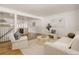 The cozy living room features a decorative rug and is open to the kitchen at 1475 S Urban Way, Lakewood, CO 80228