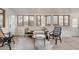 Cozy living room featuring stylish wicker furniture, bright windows and natural light at 1475 S Urban Way, Lakewood, CO 80228