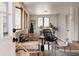 Bright sunroom with large windows, stylish furniture, and neutral decor provides an inviting and relaxing atmosphere at 1475 S Urban Way, Lakewood, CO 80228