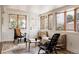 Inviting sunroom with wicker furniture, warm wood trim, and many windows perfect for enjoying natural light and views at 1475 S Urban Way, Lakewood, CO 80228