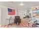 Finished basement with lounge area, workout equipment, and red and white checkered flooring at 1275 Otis St, Lakewood, CO 80214